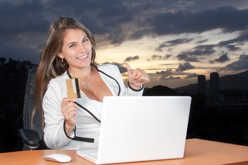 A beautiful smiling woman holding a card